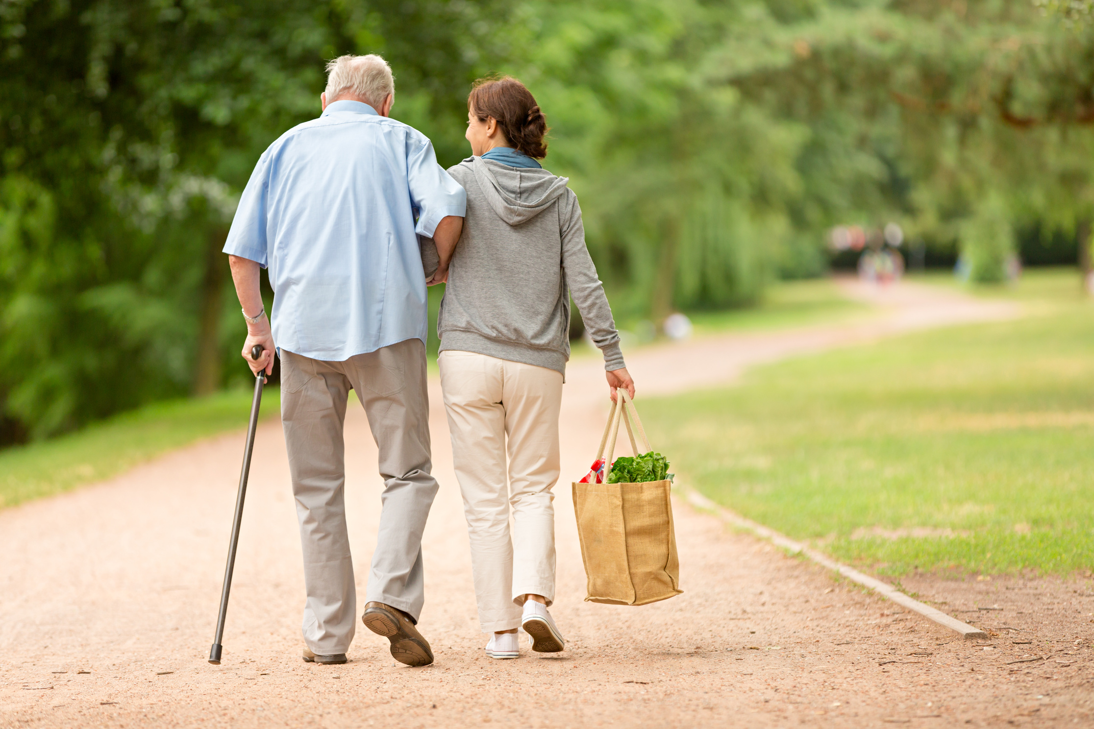 Caregiver – woman helping senior man with shopping